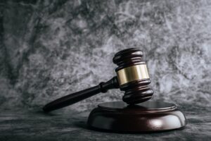 wooden judges gavel on table in a courtroom or enforcement office.