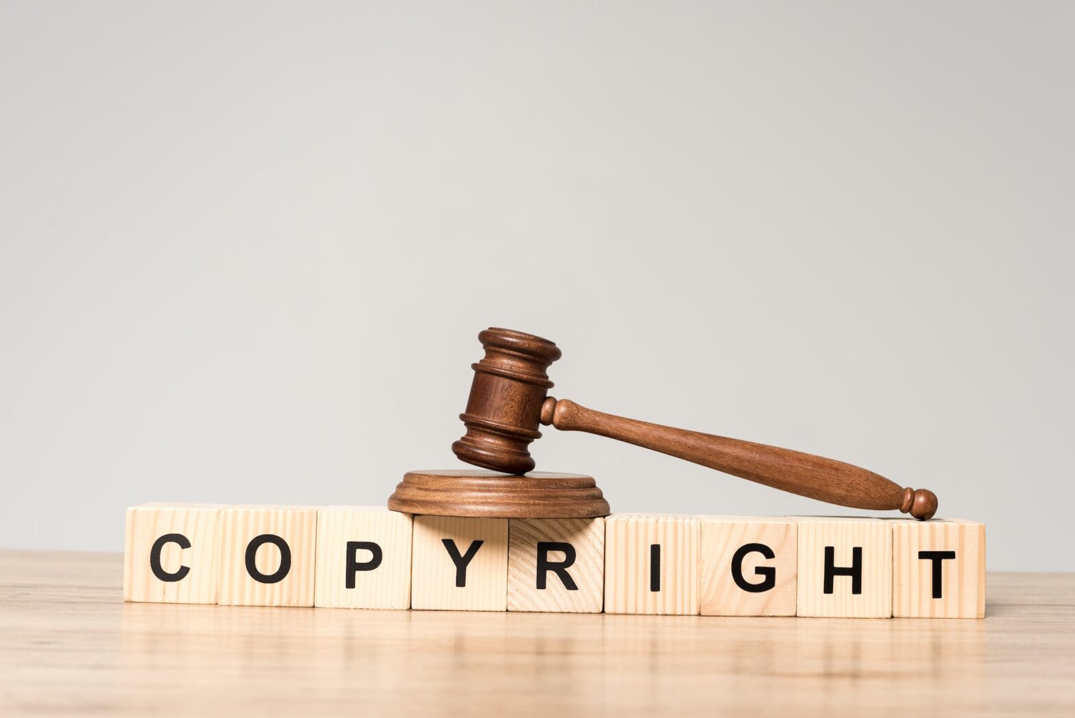 gavel on wooden cubes with word copyright on desk isolated on grey