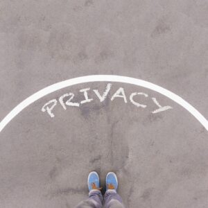 Privacy text on asphalt ground, feet and shoes on floor, personal perspective footsie concept