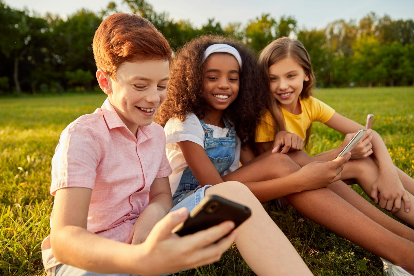 Diverse kids using smartphone together