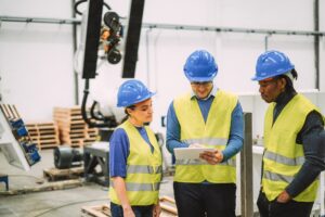Engineers working at new AI prototype inside robotic factory